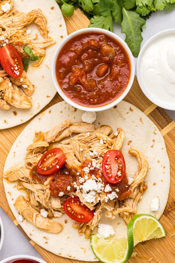 overhead shot of shredded chicken taco with toppings.