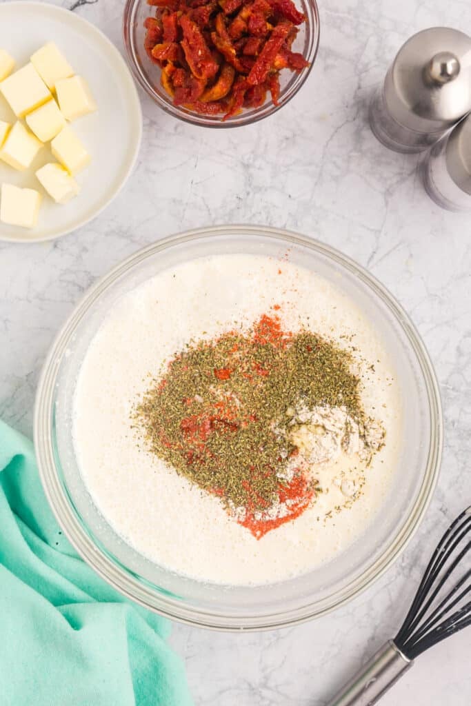seasonings and heavy cream in a mixing bowl.