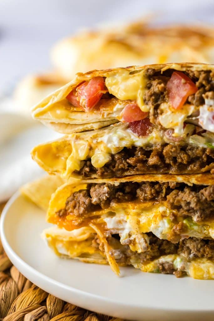 stack of crunchwrap supremes cut in half.