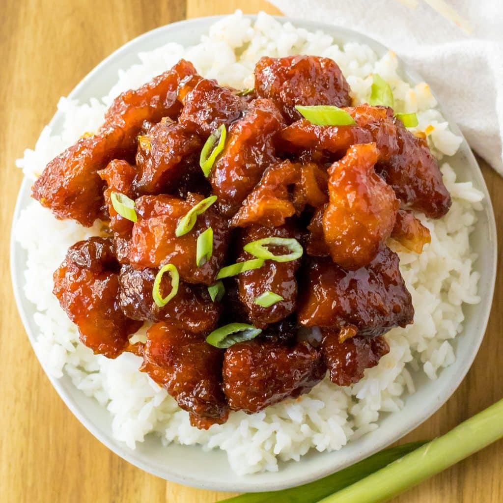 overhead shot of firecracker chicken on top of white rice.