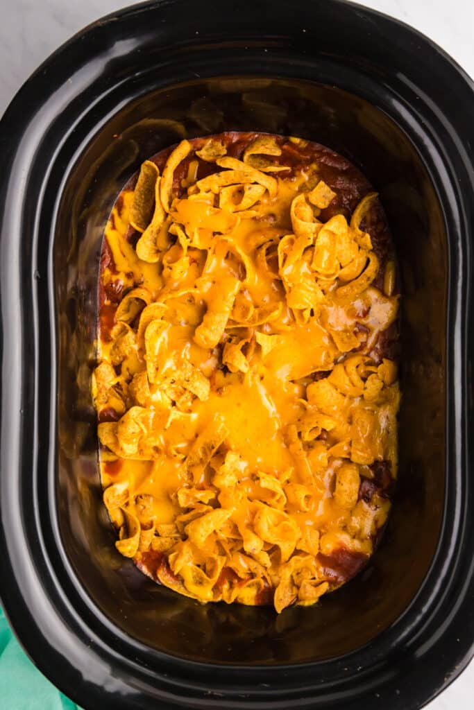 overhead shot of frito chili pie in a slow cooker.
