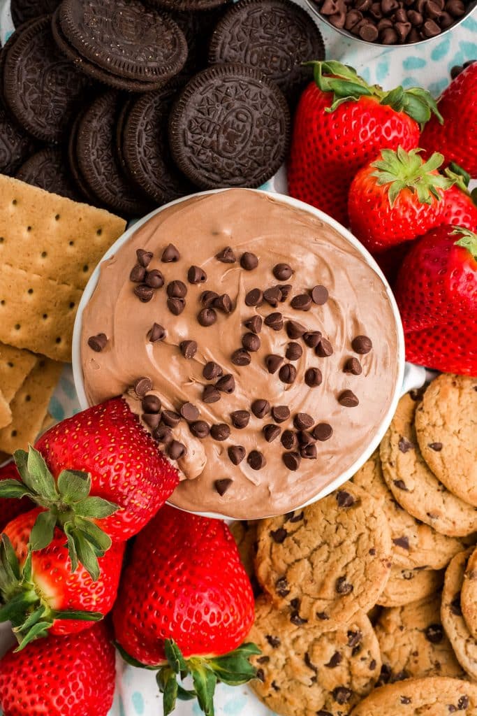 overhead shot of brownie dip with a strawberry dipped in.