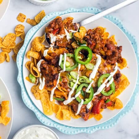plate of frito pie drizzled with sour cream.
