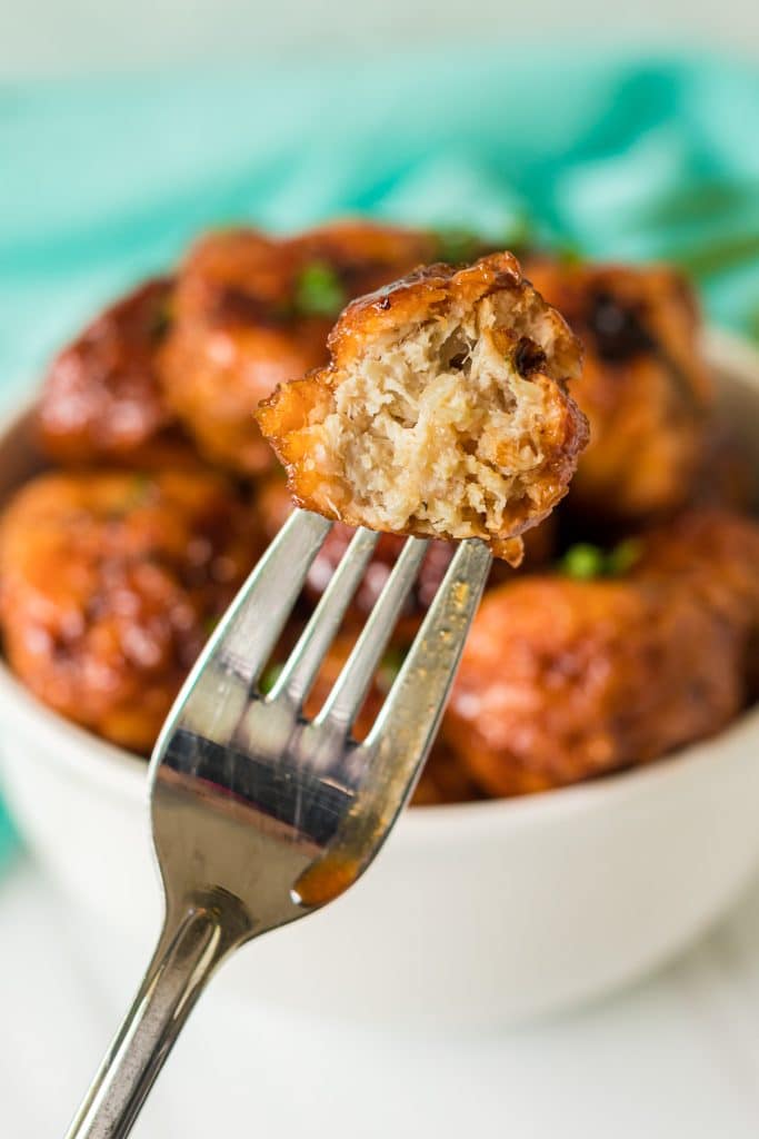 fork holding a bitten meatball.