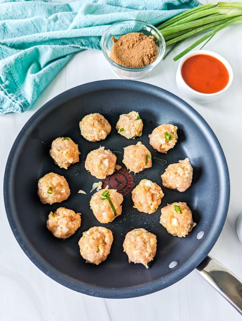 chicken meatballs in a skillet.