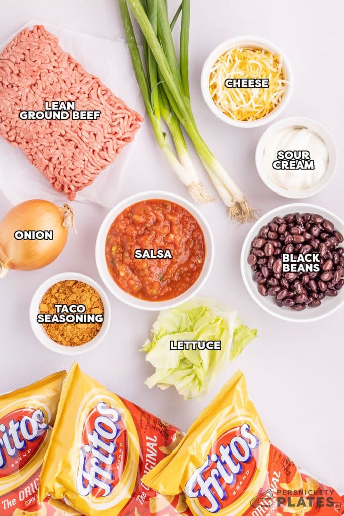 overhead shot of labeled ingredients laid out to make walking tacos.