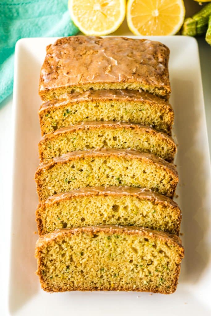 slices of lemon zucchini bread on a white platter.