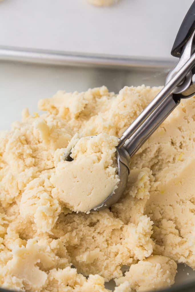 cookie scoop in a bowl of cookie dough.