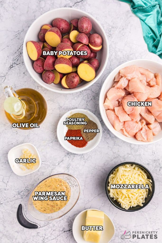 overhead shot of labeled ingredients laid out to make garlic parmesan chicken & potatoes.