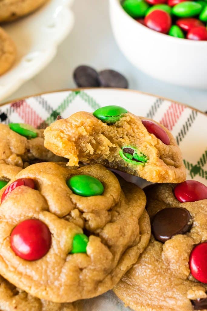plate of cookies with a bite taken out of the top cookie.