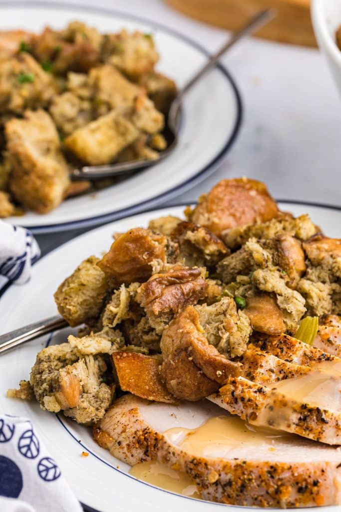 plate of sliced turkey, homemade stuffing, and gravy.