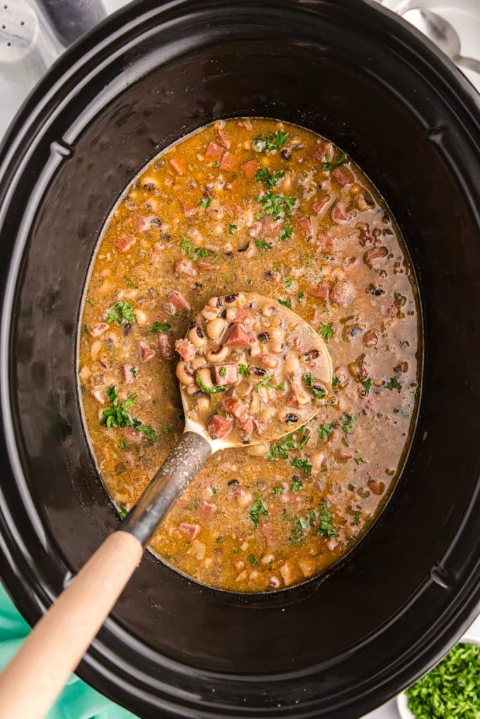 ladle in a crockpot of black eyed peas.