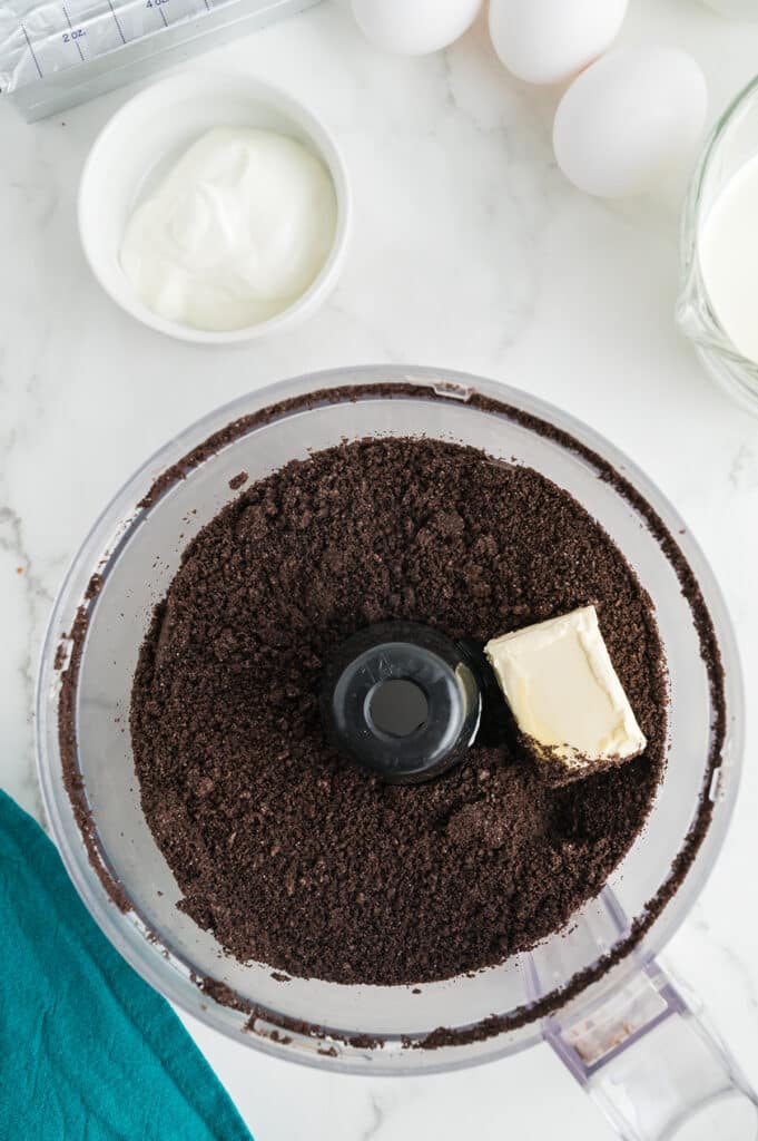 overhead shot of oreo crumbs in a food processor.