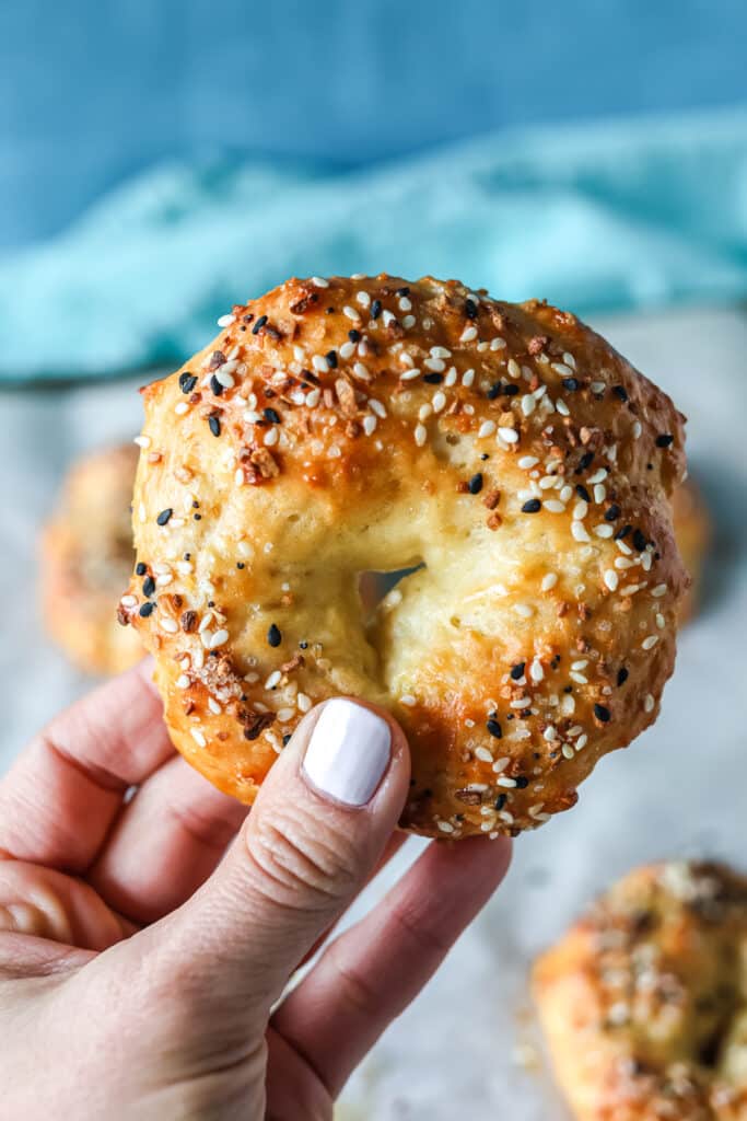 hand holding a bagel.