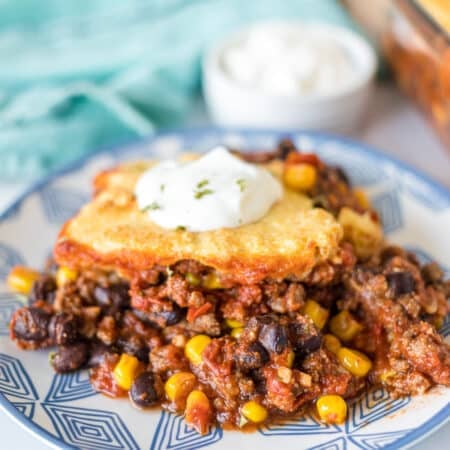 plate of chili cornbread casserole topped with sour cream.