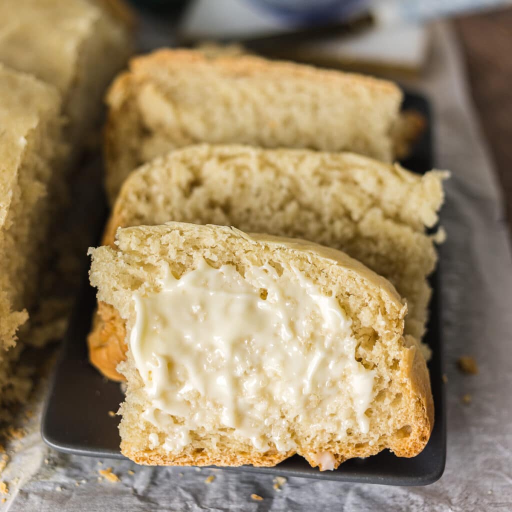 slice of buttered bread on a plate.