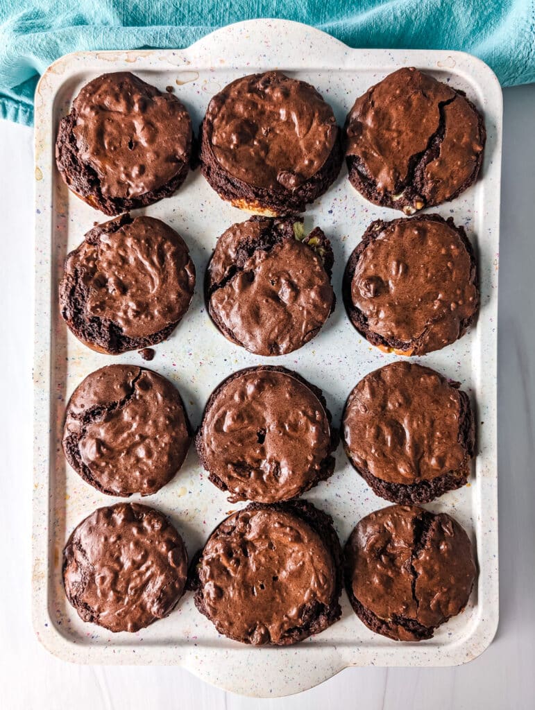 overhead shot of brookie cheesecake cups in a muffin pan.