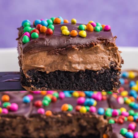 layered cosmic brownie lush being lifted from a pan.