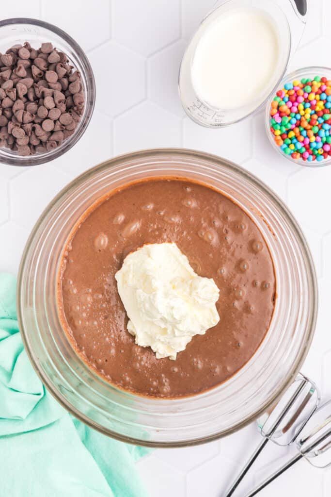 cream cheese mixing into chocolate pudding.