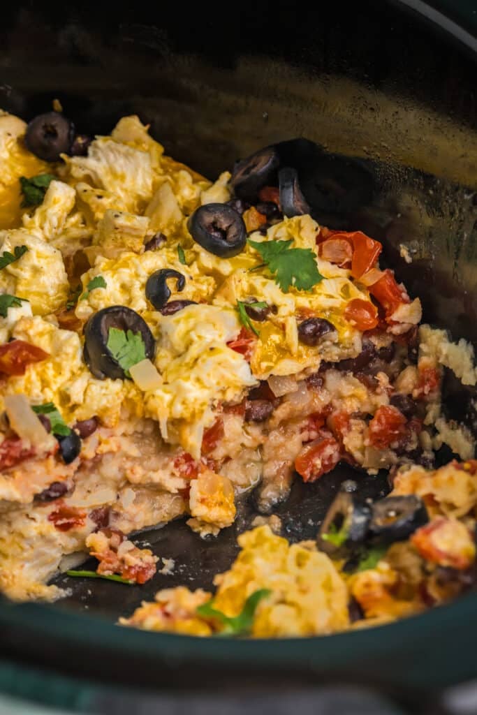 layers of chicken enchilada casserole in a crockpot.