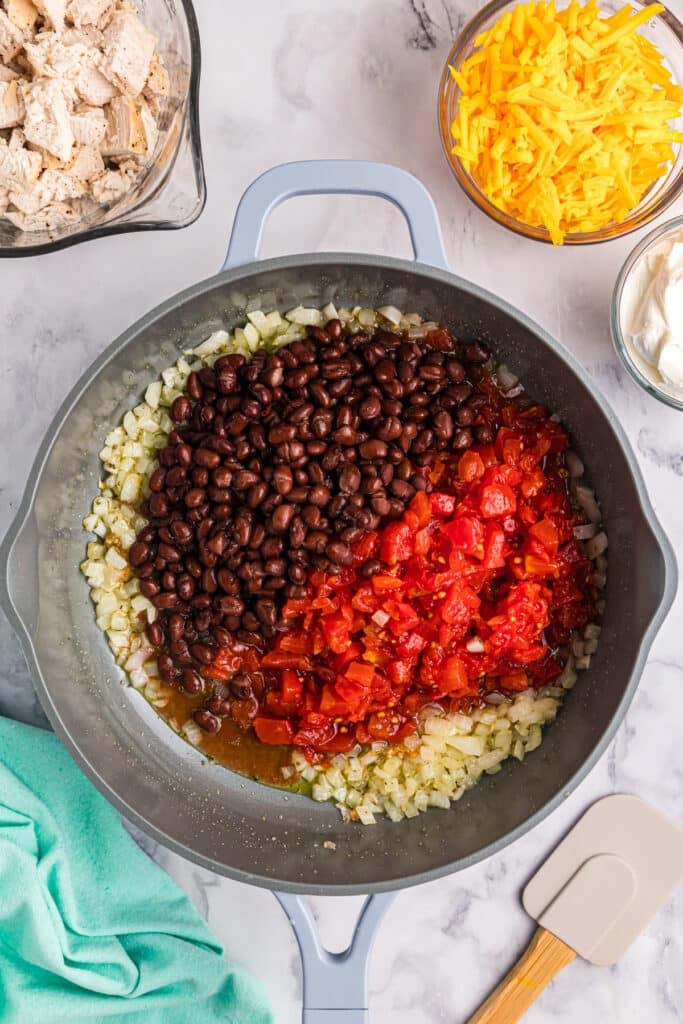 black beans, rotel, and onions in a pan.