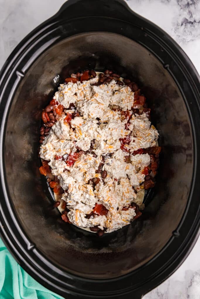 chicken casserole layers in a crockpot.