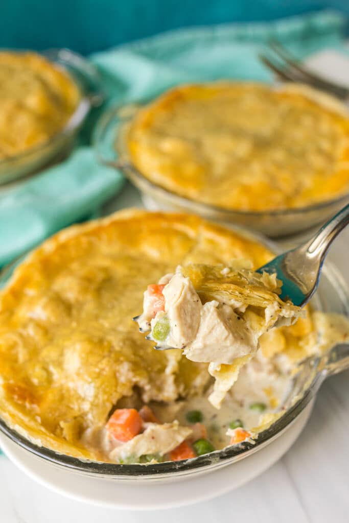 bite of chicken pot pie being lifted from the pie.