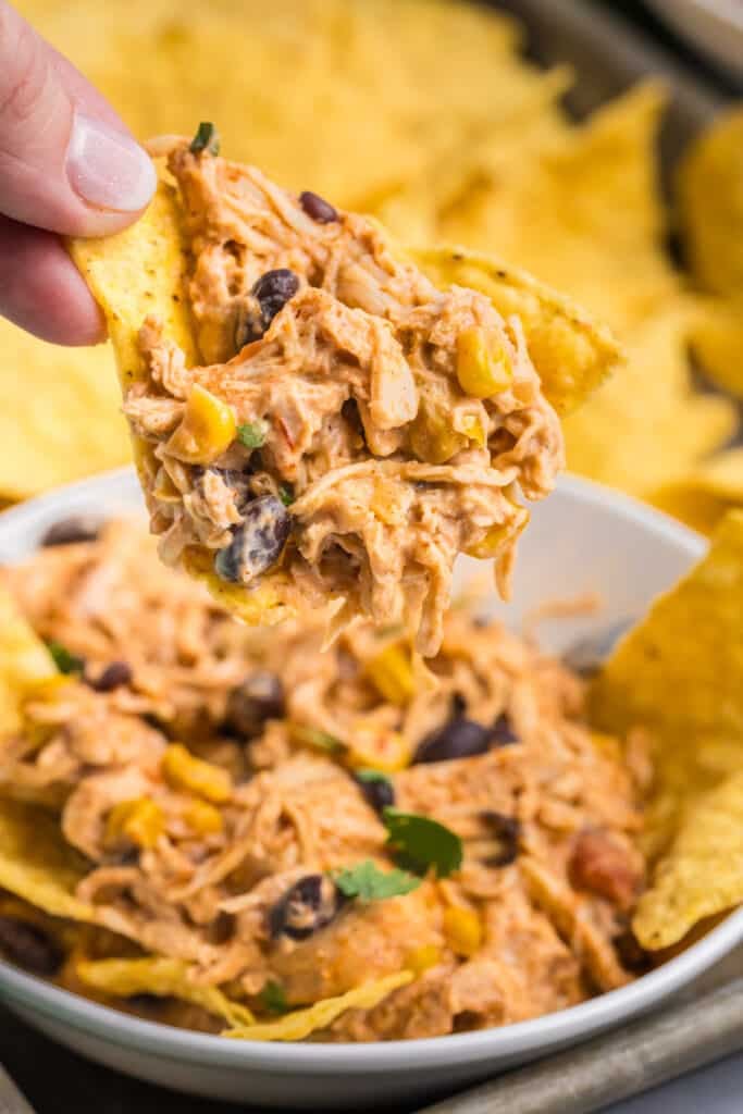 tortilla chip dipping into fiesta chicken.