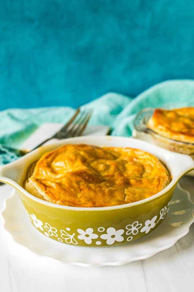 mini chicken pot pie in a green pyrex dish.