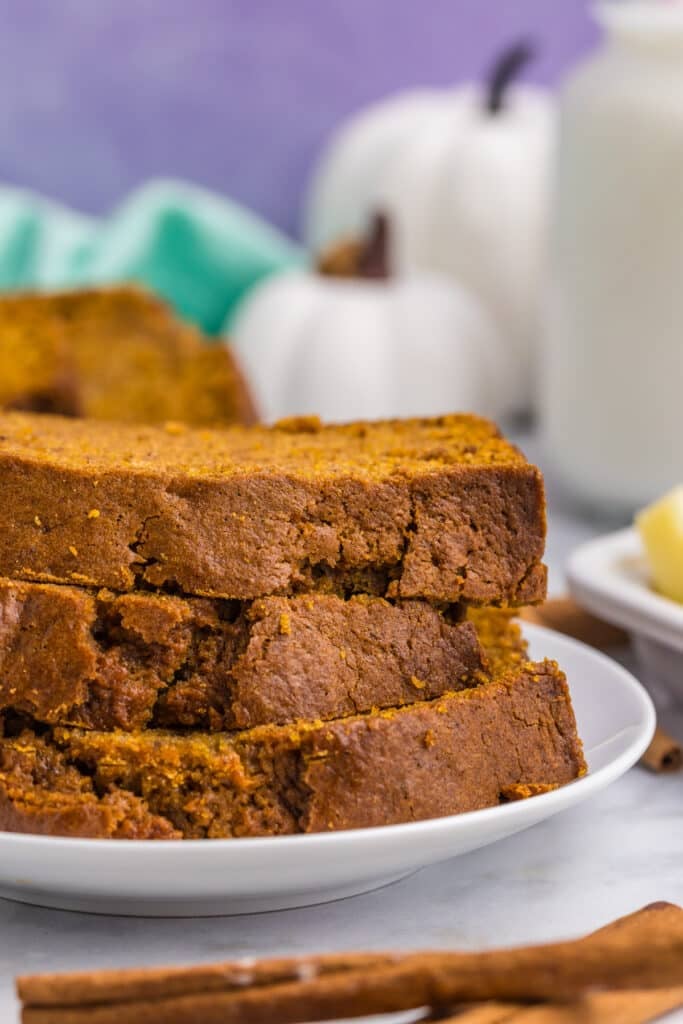stack of pumpkin bread slices on a plate.