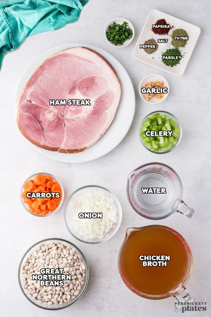 overhead shot of labeled ingredients laid out to make ham & bean soup.