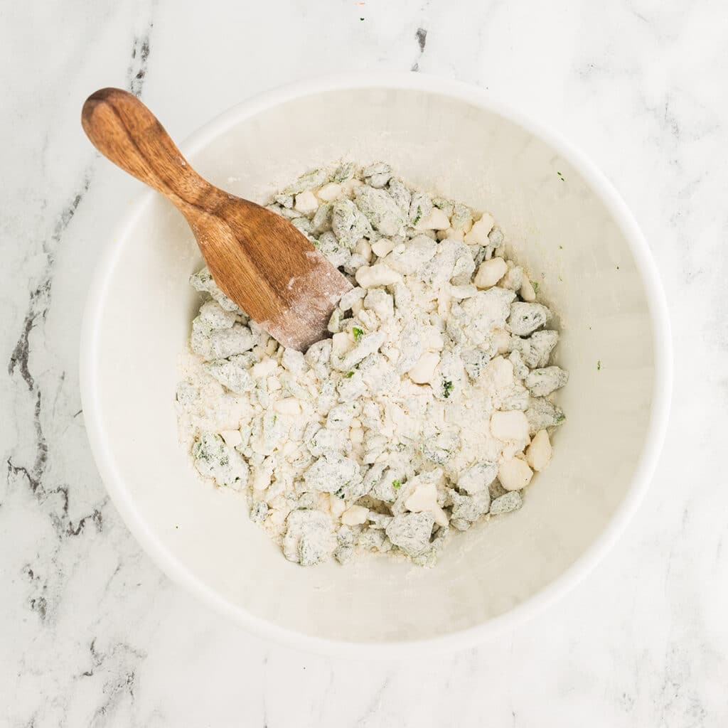 flour and spinach in a mixing bowl.