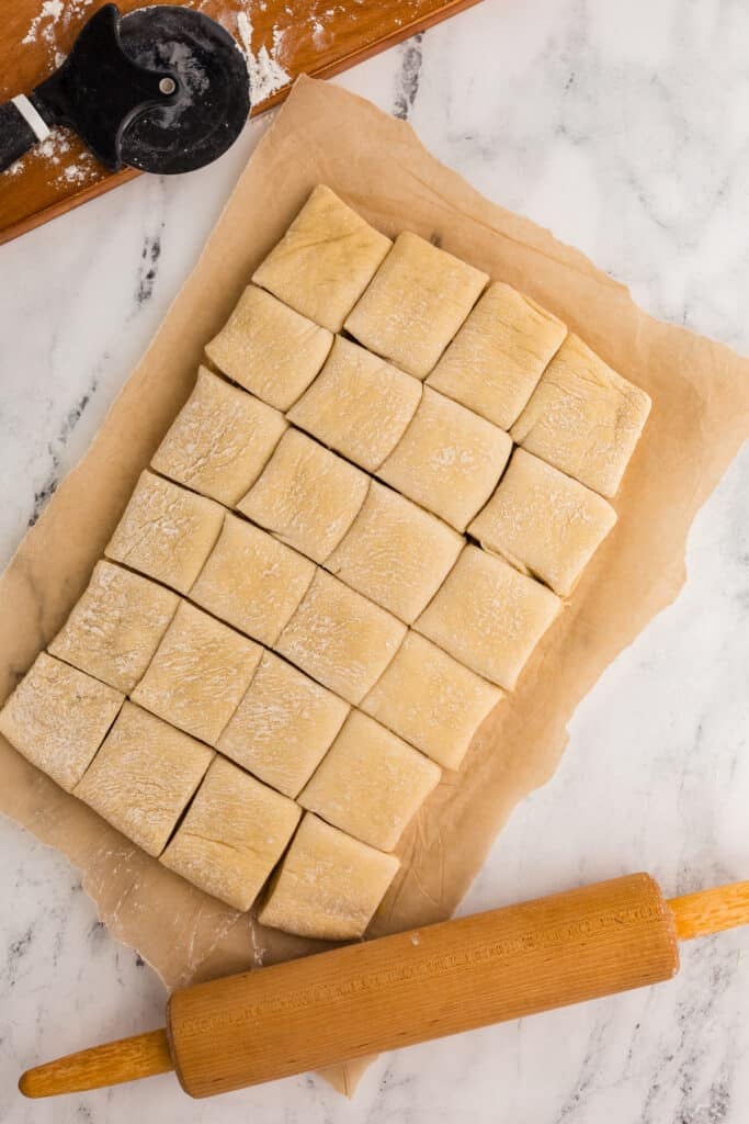 overhead shot of dough cut into 24 rolls.