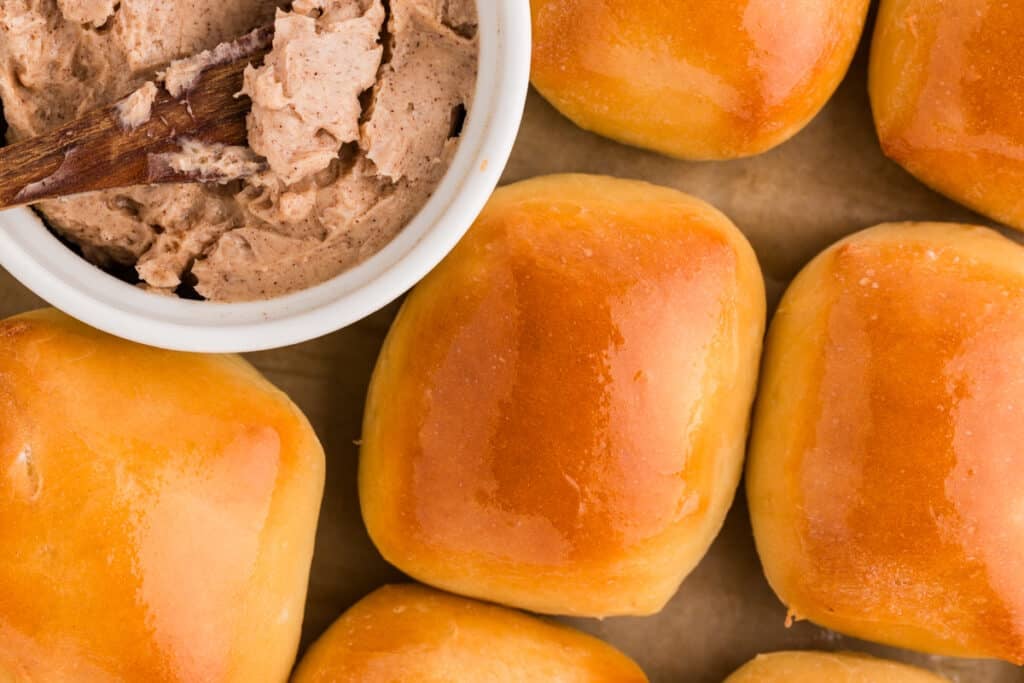 overhead shot of buttered rolls next to cinnamon honey butter.