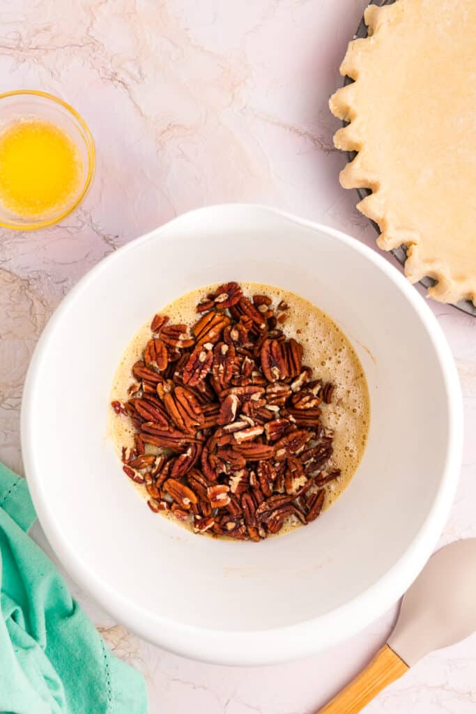 overhead shot of pecan pieces in a mixing bowl.