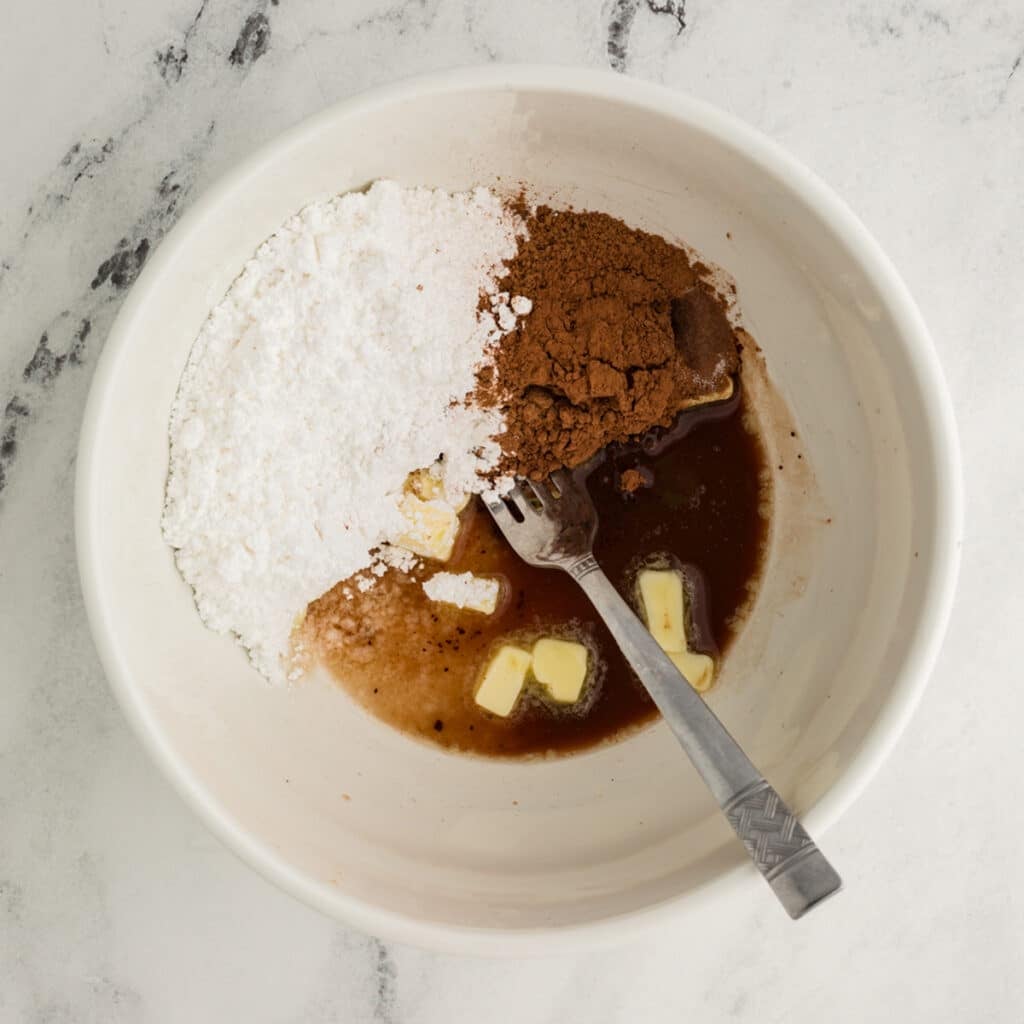 powdered sugar, cocoa powder, butter in a mixing bowl to make frosting.