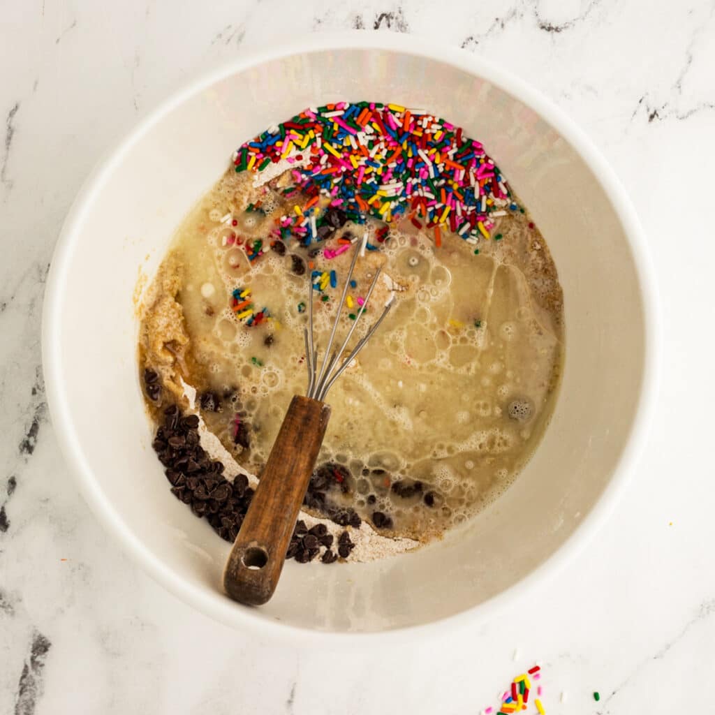 overhead shot of mixing bowl of sprinkle snack cake batter.