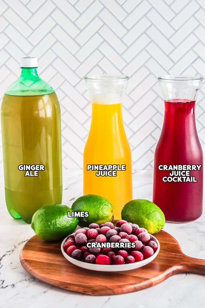 Ingredients for cranberry punch: ginger ale, pineapple juice, cranberry juice, limes, and cranberries.