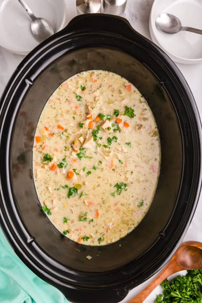 overhead shot of creamy turkey wild rice soup in a crockpot.