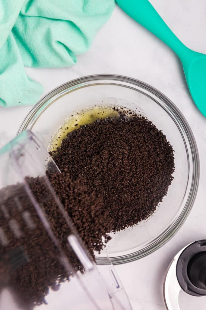 Oreo crumbs poured into melted butter.