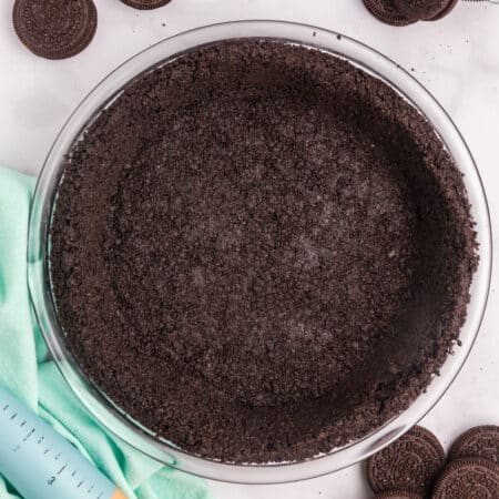 A completed Oreo pie crust in a glass dish.