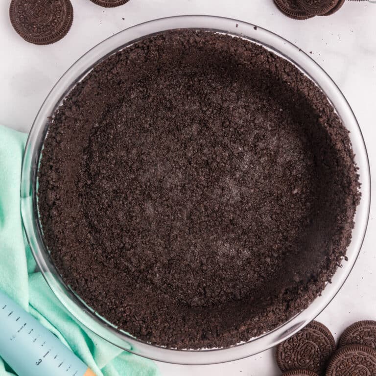 A completed Oreo pie crust in a glass dish.