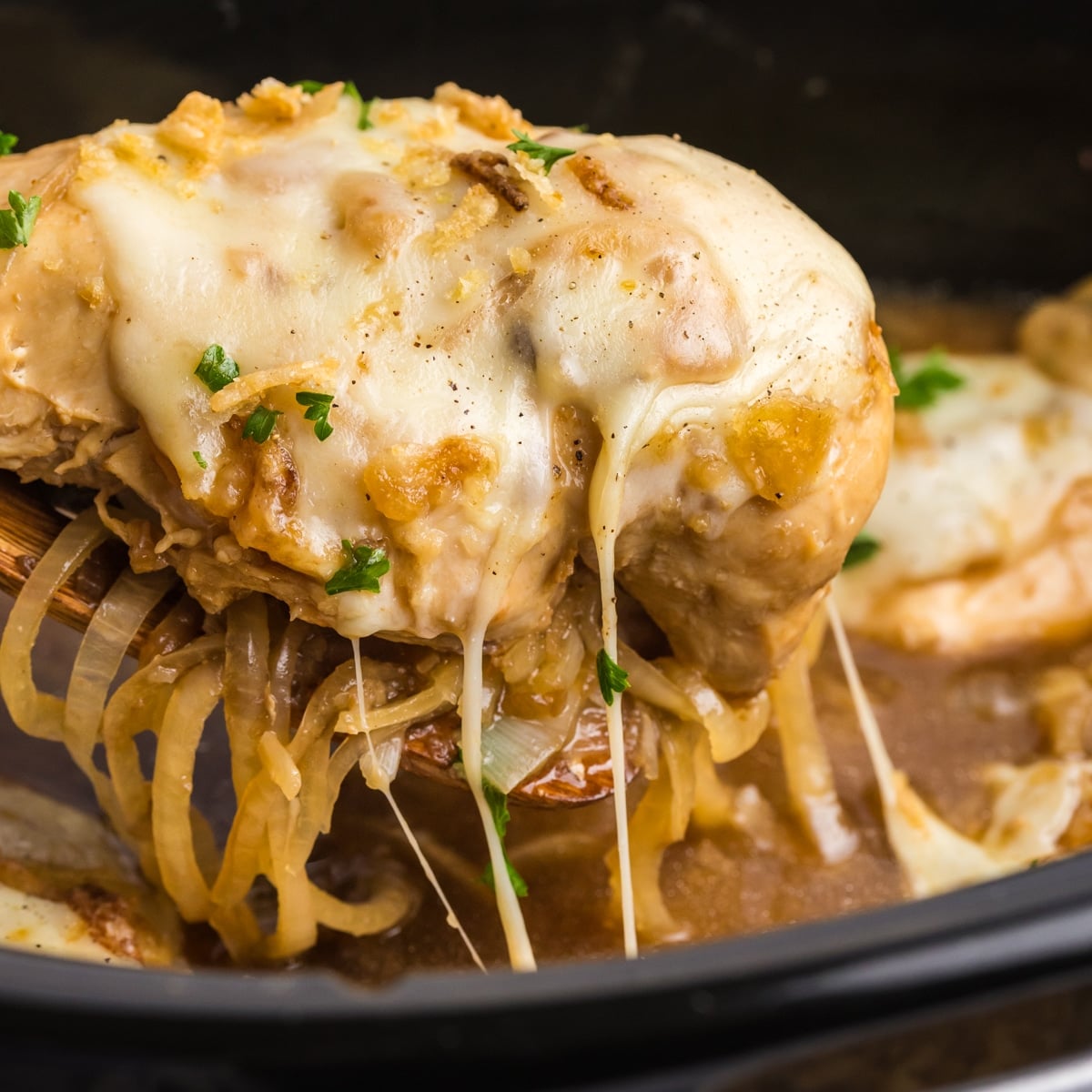 Cheesy French onion chicken lifted from slow cooker.