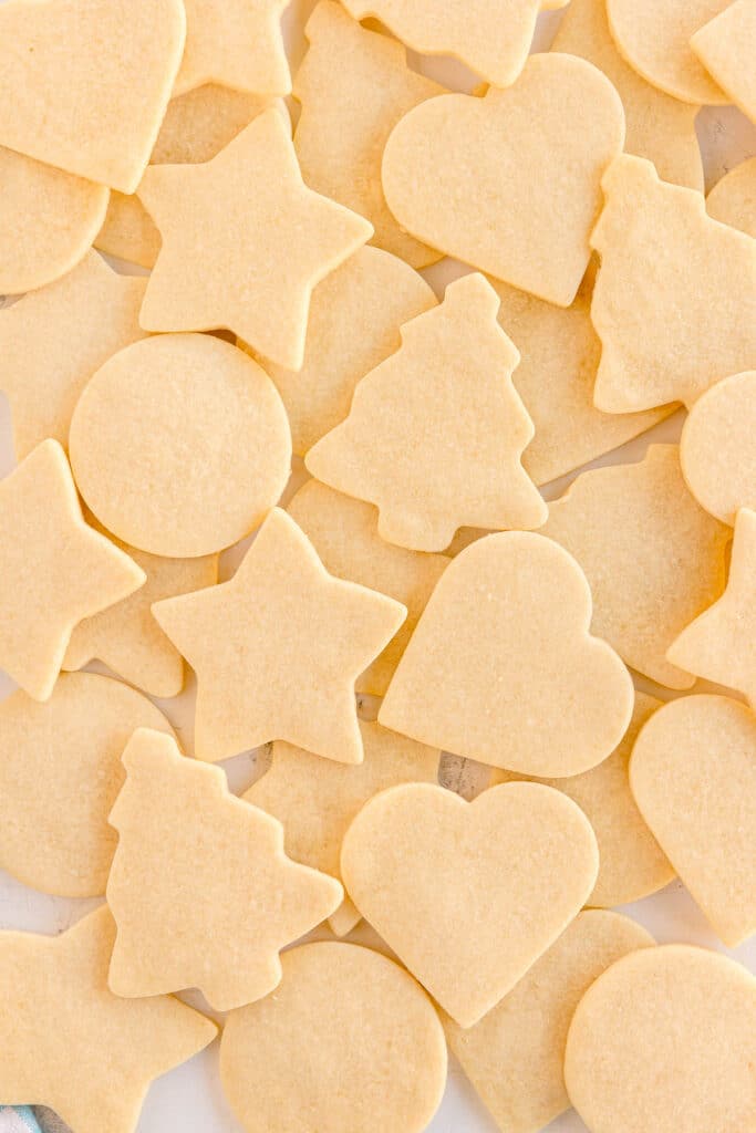 A close-up of plain sugar cookies piled together.