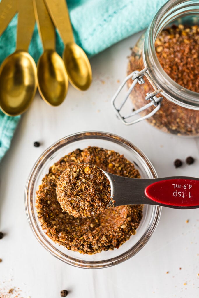 a teaspoon lifting a scoop of homemade montreal steak seasoning.