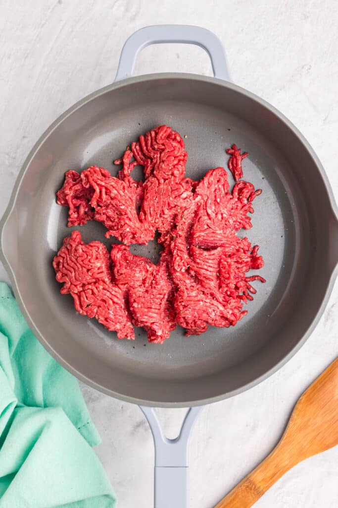 raw ground beef in a skillet.