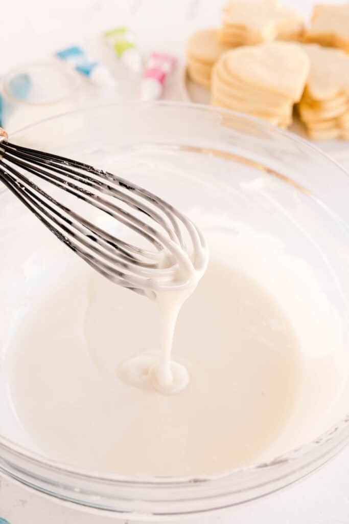 Whisk stirring sugar cookie icing.