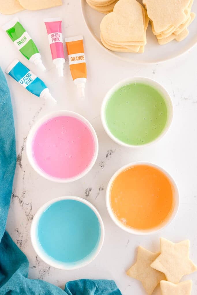 Mixed pastel icing in bowls.