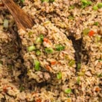 Spoonful of Cajun dirty rice with ground meat and vegetables.