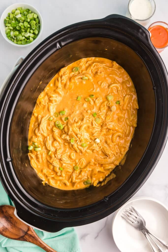 Cooked buffalo chicken mac and cheese in a slow cooker.